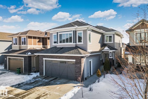 View of front of house with a shingled roof, concrete driveway, and brick siding - 1611 158 Street, Edmonton, AB - Outdoor