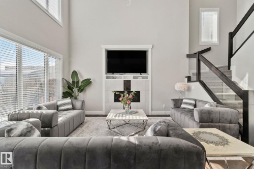 Living room with a high ceiling and wood finished floors - 1611 158 Street, Edmonton, AB - Indoor Photo Showing Living Room