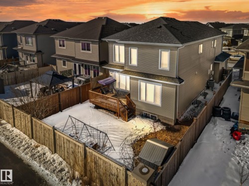 Rear view of house with a fenced backyard, a deck, a residential view, and roof with shingles - 1611 158 Street, Edmonton, AB - Outdoor With Exterior