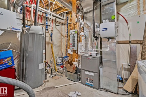 Utility room with electric panel, gas water heater, and heating unit - 1611 158 Street, Edmonton, AB - Indoor Photo Showing Basement