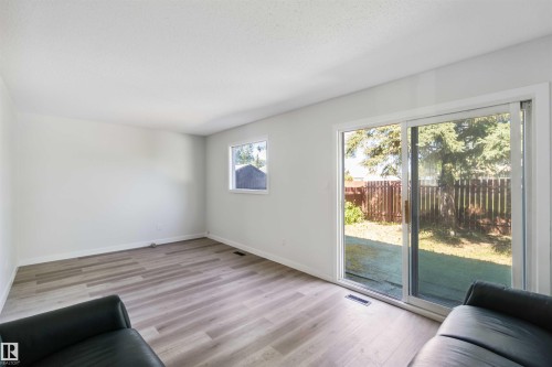 Living area featuring light wood-type flooring and baseboards - 1096 Millbourne Road E, Edmonton, AB - Indoor
