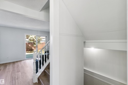 Stairway featuring wood finished floors and baseboards - 1096 Millbourne Road E, Edmonton, AB - Indoor Photo Showing Other Room