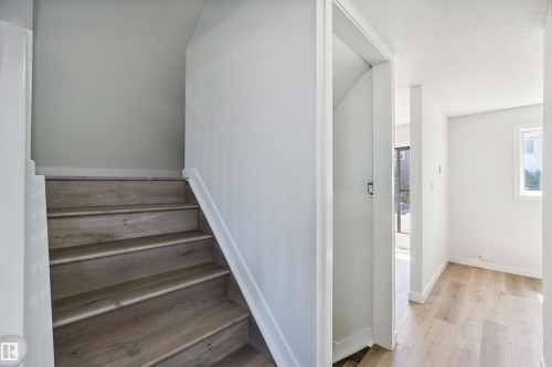 Stairway featuring wood finished floors and a textured ceiling - 1096 Millbourne Road E, Edmonton, AB - Indoor Photo Showing Other Room