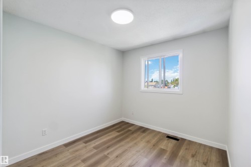 Spare room featuring baseboards and light wood-style floors - 1096 Millbourne Road E, Edmonton, AB - Indoor Photo Showing Other Room