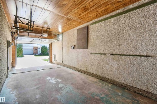 Garage with a textured wall and wooden ceiling - 1096 Millbourne Road E, Edmonton, AB - Indoor Photo Showing Garage