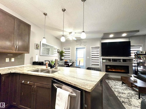 14 Hickory Road, Fort Saskatchewan, AB - Indoor Photo Showing Kitchen With Fireplace With Double Sink With Upgraded Kitchen