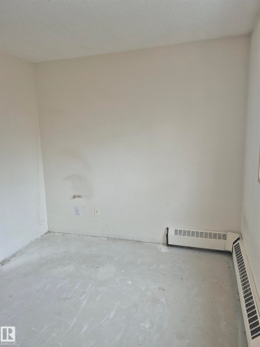 Unfurnished room featuring concrete floors - 410 17467 98A Avenue, Edmonton, AB - Indoor Photo Showing Other Room