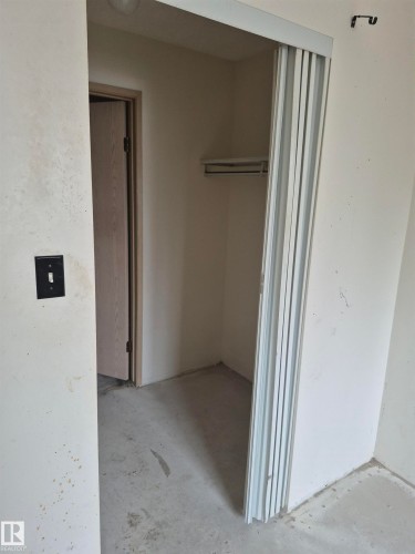 Hall with unfinished concrete flooring - 410 17467 98A Avenue, Edmonton, AB - Indoor Photo Showing Other Room