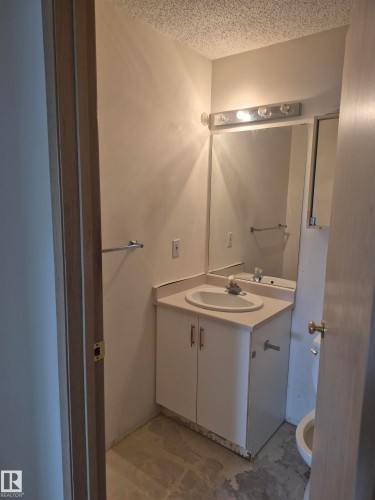 Half bath featuring vanity and a textured ceiling - 410 17467 98A Avenue, Edmonton, AB - Indoor Photo Showing Bathroom
