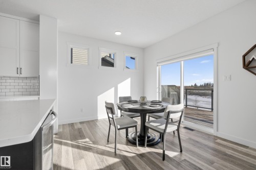 Dining area with light wood-style floors and beverage cooler - 9727 205 Street, Edmonton, AB - Indoor Photo Showing Dining Room