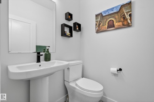 Bathroom with toilet and baseboards - 9727 205 Street, Edmonton, AB - Indoor Photo Showing Bathroom