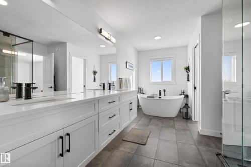 Full bathroom with a stall shower, double vanity, a freestanding bath, and recessed lighting - 9727 205 Street, Edmonton, AB - Indoor Photo Showing Bathroom