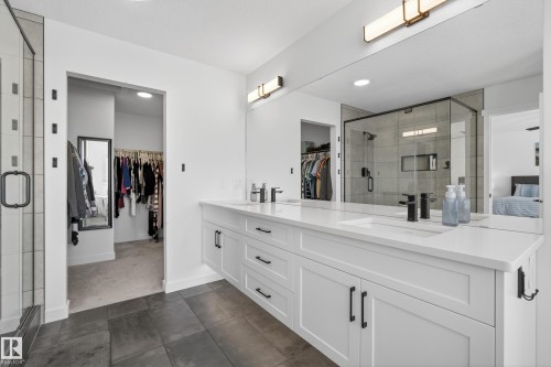 Full bathroom featuring a shower stall, a walk in closet, double vanity, ensuite bathroom, and recessed lighting - 9727 205 Street, Edmonton, AB - Indoor Photo Showing Bathroom