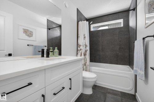 Bathroom with vanity and shower / bath combo with shower curtain - 9727 205 Street, Edmonton, AB - Indoor Photo Showing Bathroom