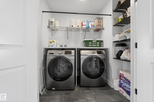 Laundry room featuring independent washer and dryer and concrete floors - 9727 205 Street, Edmonton, AB - Indoor Photo Showing Laundry Room