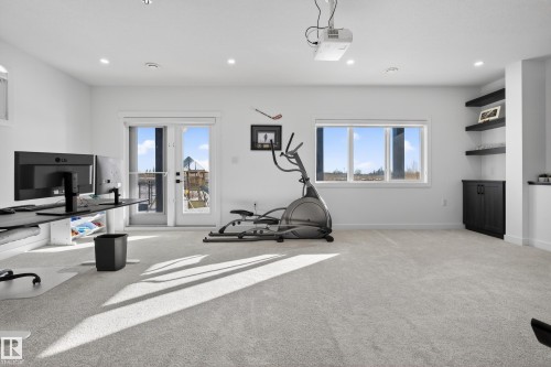 Workout area featuring light carpet, healthy amount of natural light, and recessed lighting - 9727 205 Street, Edmonton, AB - Indoor Photo Showing Other Room