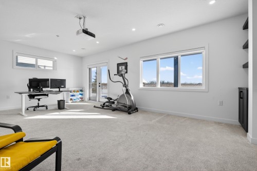 Workout area with light colored carpet and recessed lighting - 9727 205 Street, Edmonton, AB - Indoor Photo Showing Gym Room