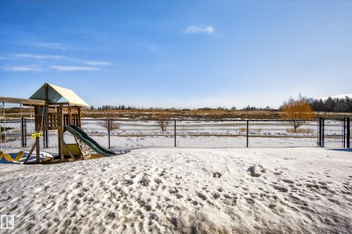 Yard covered in snow featuring a playground and a gate - 9727 205 Street, Edmonton, AB - Outdoor