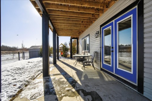 View of patio featuring an outbuilding and outdoor dining area - 9727 205 Street, Edmonton, AB - Outdoor With Deck Patio Veranda With Exterior