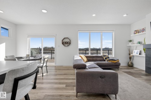 Living area featuring light wood finished floors, plenty of natural light, and recessed lighting - 9727 205 Street, Edmonton, AB - Indoor Photo Showing Living Room
