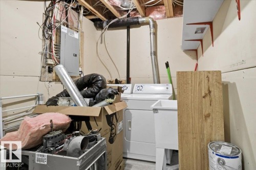 Laundry area featuring a top-loading washing machine and a utility sink - 6 6410 134 Avenue Nw, Edmonton, AB - Indoor
