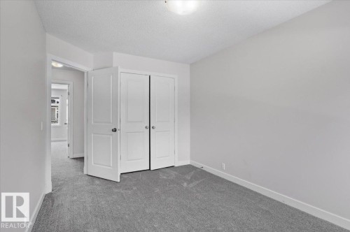 Bedroom featuring neutral gray carpeting and white walls - 6 6410 134 Avenue Nw, Edmonton, AB - Indoor Photo Showing Other Room