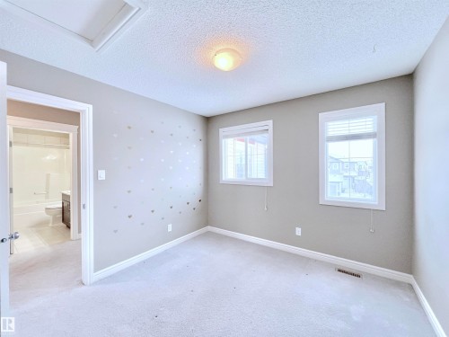 Empty room featuring a textured ceiling and light colored carpet - 4604 Westcliff Point(E), Edmonton, AB - Indoor Photo Showing Other Room