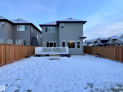 Snow covered back of property featuring a fenced backyard, a residential view, and a wooden deck - 4604 Westcliff Point(E), Edmonton, AB - Outdoor With Deck Patio Veranda With Exterior