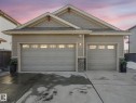 View of front of house with stone siding, concrete driveway, and a shingled roof - 117 Mcdowell Wynd, Leduc, AB  - Outdoor 