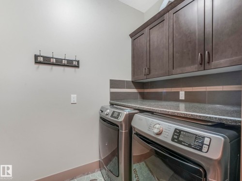 Laundry area with cabinet space and washer and dryer - 117 Mcdowell Wynd, Leduc, AB - Indoor Photo Showing Laundry Room