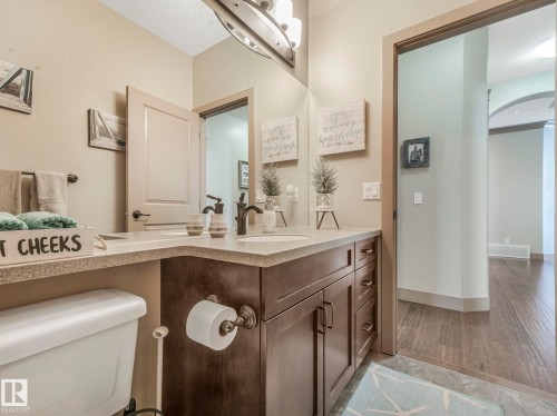 Bathroom with vanity, light wood-type flooring, and a textured ceiling - 117 Mcdowell Wynd, Leduc, AB - Indoor Photo Showing Bathroom