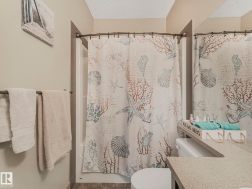 Bathroom with vanity and shower / tub combo - 117 Mcdowell Wynd, Leduc, AB - Indoor Photo Showing Bathroom