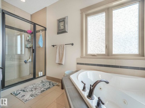 Bathroom featuring a stall shower and a whirlpool tub - 117 Mcdowell Wynd, Leduc, AB - Indoor Photo Showing Bathroom