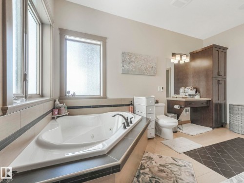 Bathroom with a jetted tub and light tile patterned floors - 117 Mcdowell Wynd, Leduc, AB - Indoor Photo Showing Bathroom