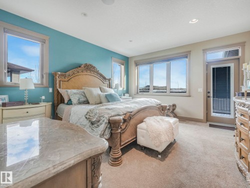 Bedroom featuring light colored carpet and access to outside - 117 Mcdowell Wynd, Leduc, AB - Indoor Photo Showing Bedroom