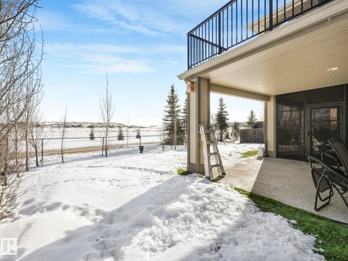 Yard covered in snow with a patio area and a balcony - 117 Mcdowell Wynd, Leduc, AB - Outdoor