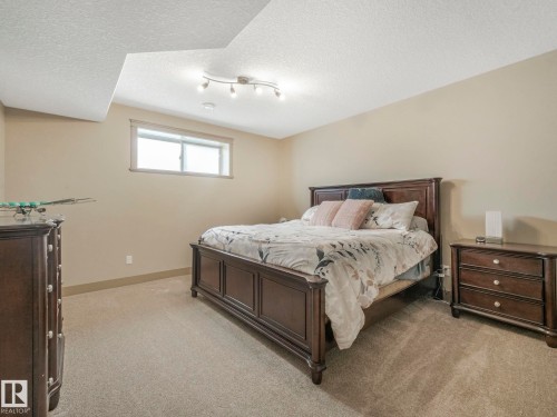 Bedroom with light carpet and a textured ceiling - 117 Mcdowell Wynd, Leduc, AB - Indoor Photo Showing Bedroom