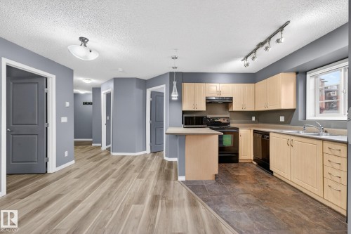 102 11445 Ellerslie Road Sw, Edmonton, AB - Indoor Photo Showing Kitchen With Double Sink