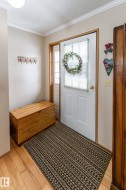 Entrance foyer featuring light wood-style flooring and ornamental molding - 
