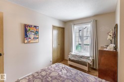 Bedroom featuring wood finished floors, a textured ceiling, and a closet - 