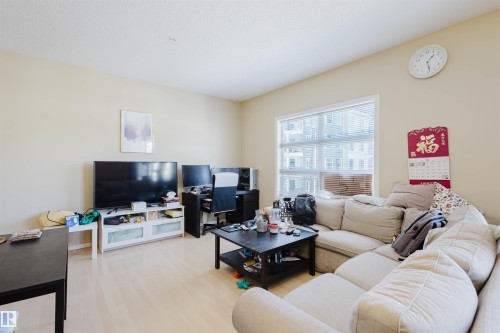 Living area featuring wood finished floors - 207 9910 111 Street, Edmonton, AB - Indoor Photo Showing Living Room