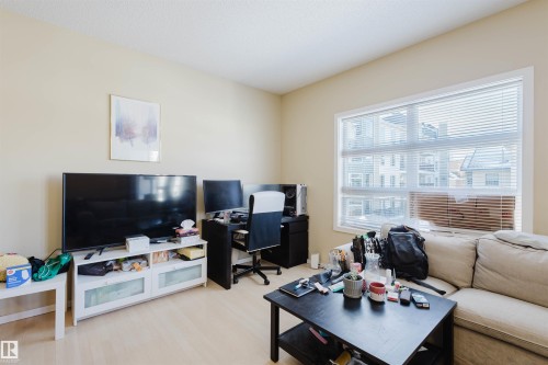 Living room featuring a desk and light wood-style floors - 207 9910 111 Street, Edmonton, AB - Indoor