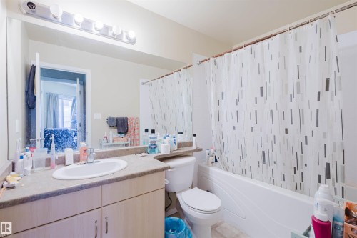 Full bath with vanity and shower / bathtub combination with curtain - 207 9910 111 Street, Edmonton, AB - Indoor Photo Showing Bathroom