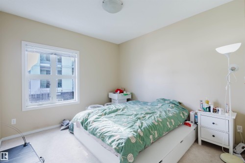 Carpeted bedroom with baseboards - 207 9910 111 Street, Edmonton, AB - Indoor Photo Showing Bedroom