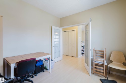 Office space featuring french doors and light wood-style floors - 207 9910 111 Street, Edmonton, AB - Indoor Photo Showing Office