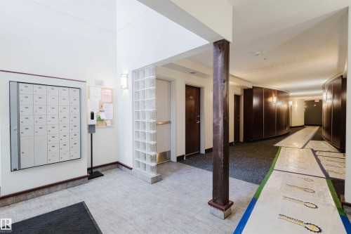 Foyer featuring mail area and baseboards - 207 9910 111 Street, Edmonton, AB - Indoor Photo Showing Other Room