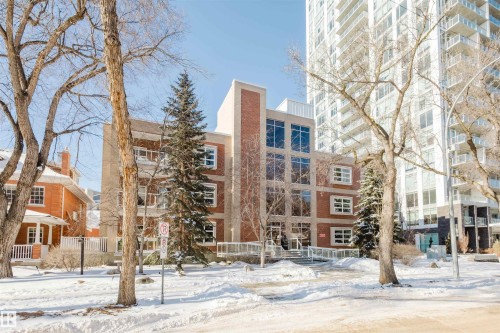 Snow covered property featuring a view of apartment building / complex - 207 9910 111 Street, Edmonton, AB - Outdoor With Facade