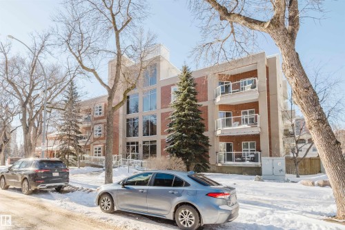 Snow covered property featuring a view of apartment building / complex - 207 9910 111 Street, Edmonton, AB - Outdoor With Facade