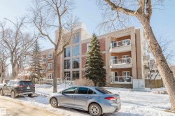 Snow covered property featuring a view of apartment building / complex - 