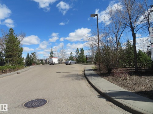 Paved street with concrete sidewalk and established street lighting - 415 2590 Anderson Way, Edmonton, AB - Outdoor With View
